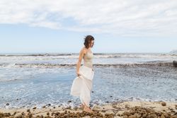 Charming young woman on shore near water