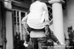 Grayscale photo of man holding woman on his back 4B7QMb