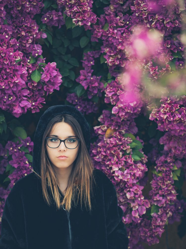 Woman on background of stunning violet flowers