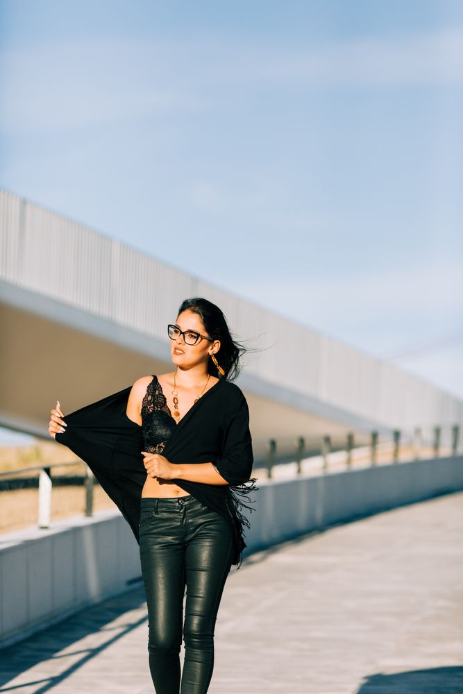 Trendy female standing on urban background