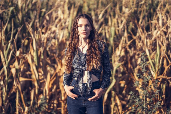 A stunning fashion portrait captured in a picturesque cornfield during the enchanting golden hour