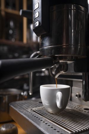 Barista making coffee using a coffee maker