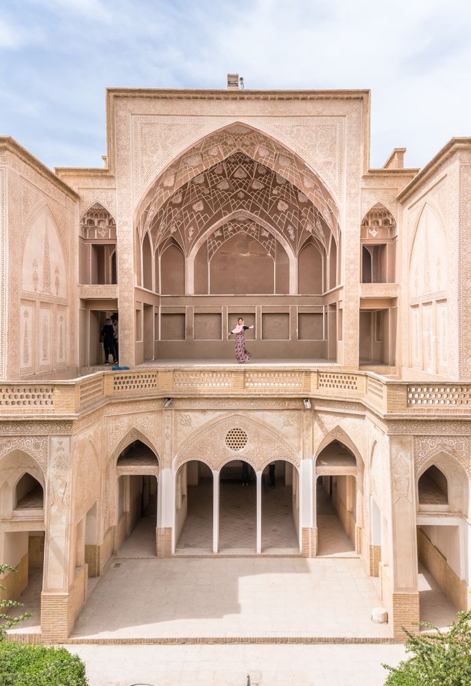 Woman standing on terrace of traditional oriental mosque