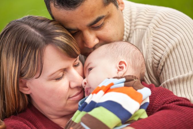 Happy Family Posing for A Portrait in the Park