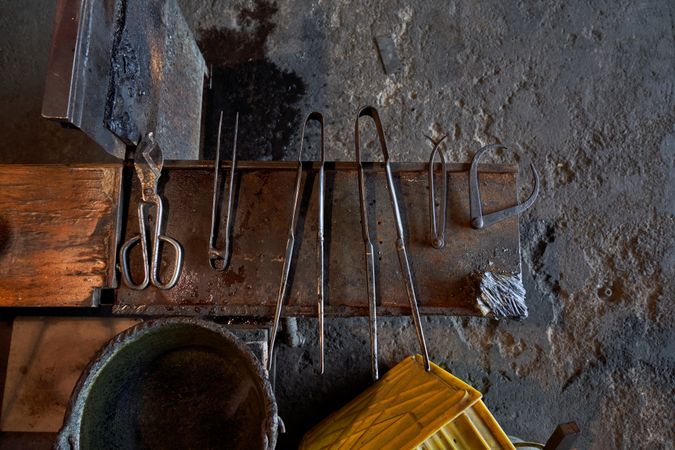 Metal tools on workbench in glass making factory