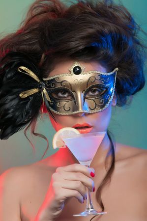 Woman in mask holding glass of drink
