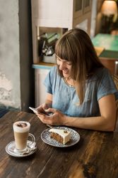 Woman using smartphone in cafe