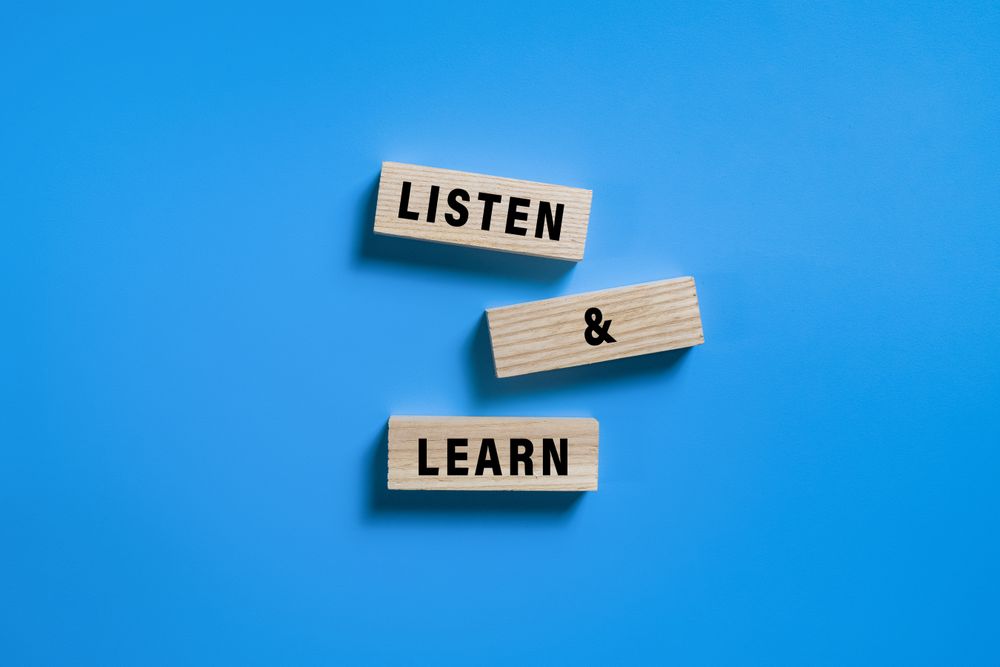 listen and learn words on turn wooden blocks isolated on blue background
