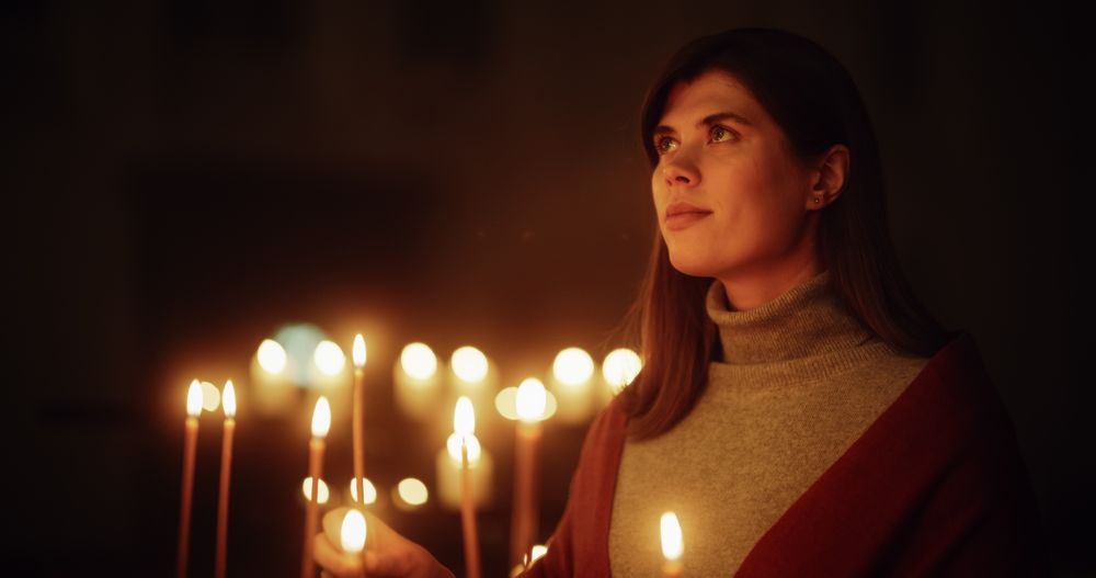 Devout Christian Woman Lighting a Candle in Church, Praying and Expressing Devotion to the Lord.