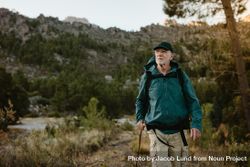 Mature man walking on mountain trail bYNw10