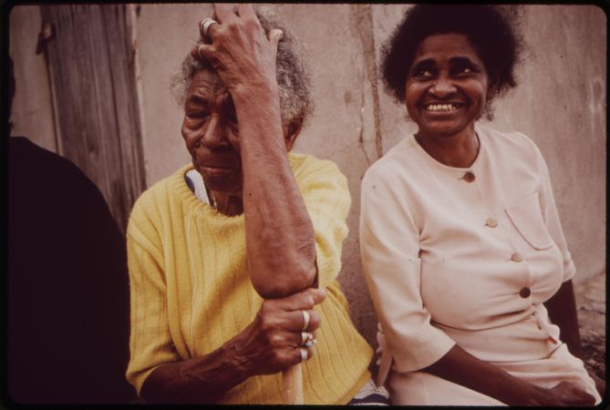 Two older Puerto Rican woman sitting outside