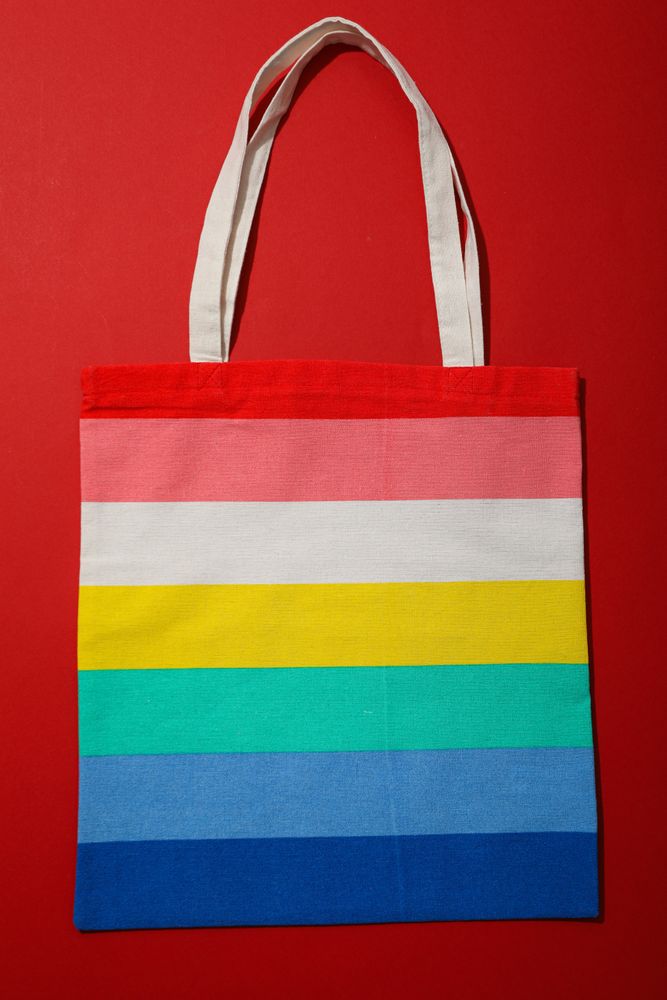 Concept of Pride parade, rainbow shopper, on color background.
