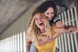 Two playful friends having fun while out in the city