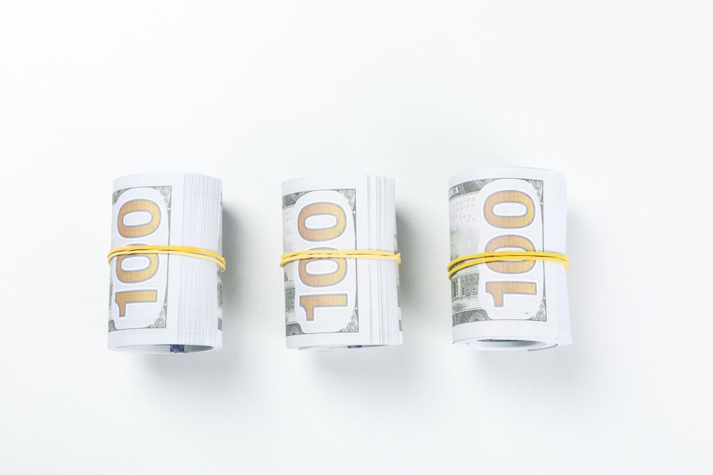 Twisted money with a rubber band, on a light background.