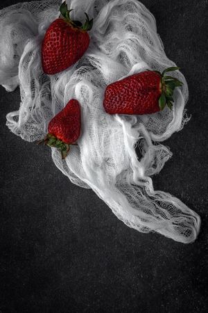 Red and fresh strawberries flat lay in a piece of cloth