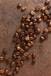 Coffee beans on brown background