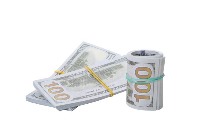 Stacks of American cash money, isolated on light background