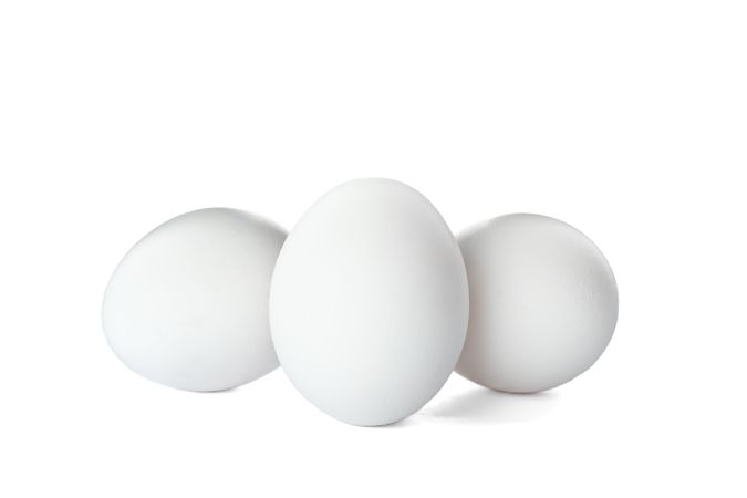 Few raw chicken eggs on plain background