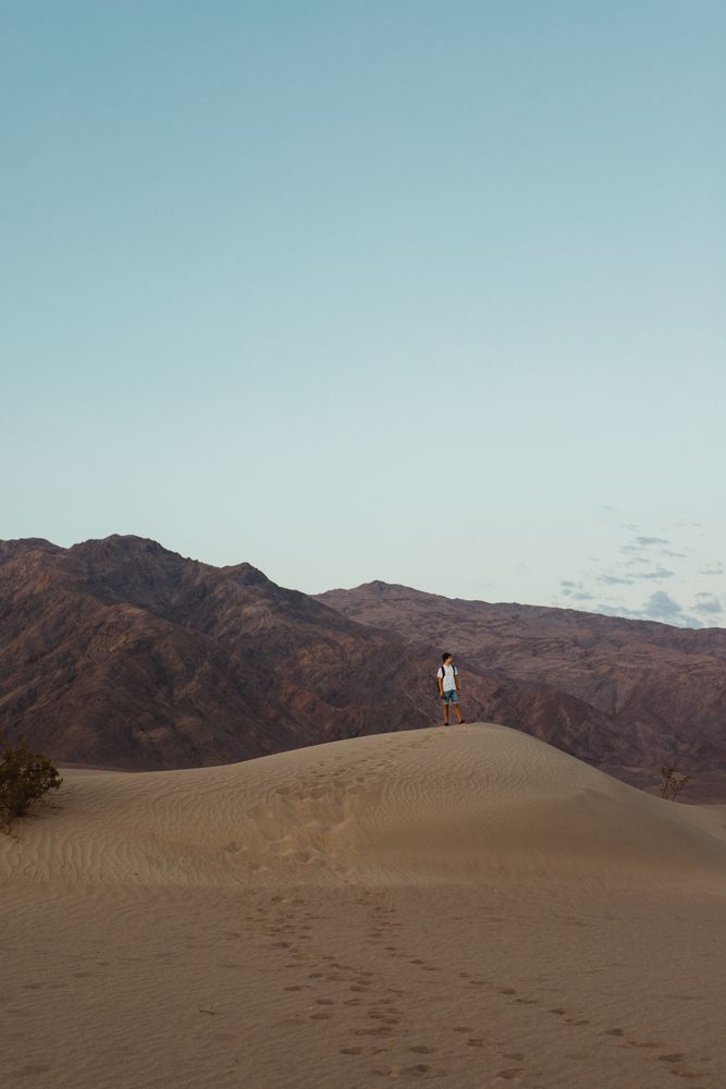 Lonely man walking in sandy desert