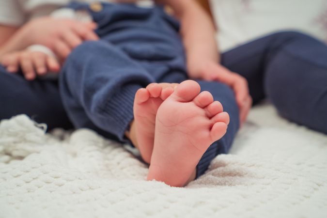 Woman with little baby on bed