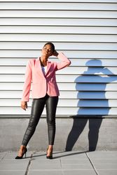 Woman in modern business suit standing outside with shadow