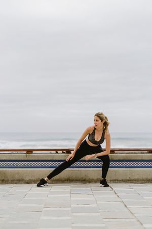 Sportswoman working out at city street