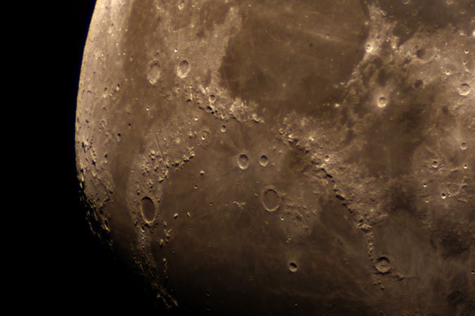 Close-up of lunar surface showing detailed craters and rugged terrain