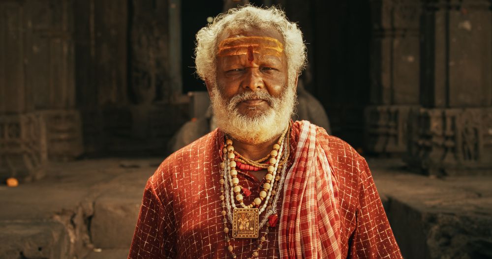 Authentic Footage of Hindu Priest Putting a Tilaka on Female Temple Follower and her Male Kid.