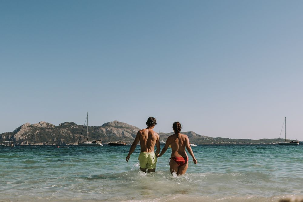 Happy couple walking on sea