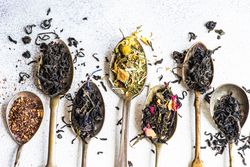 Top view of loose leaf tea in vintage spoons