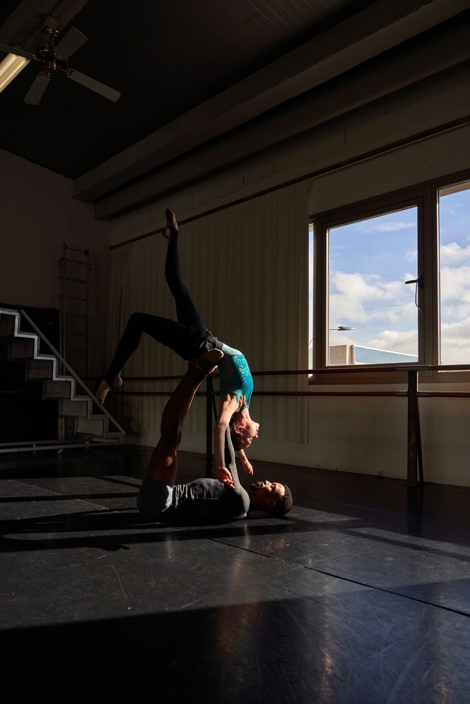 Couple of dancers in a class doing a training in ballet academy