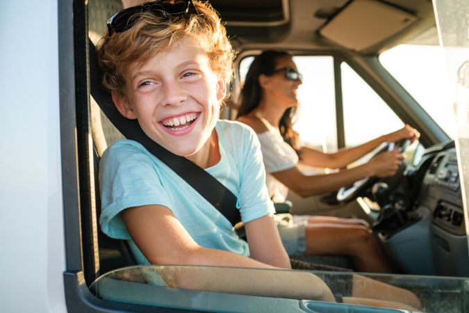 Kid with mother having summer trip by car