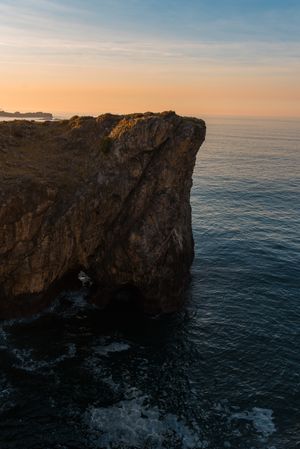 Majestic cliffs of ocean coastline in sunset