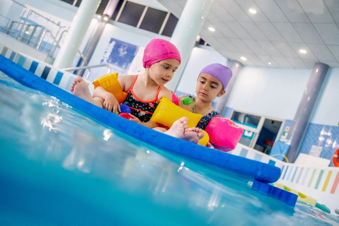 girl with water wings in swimming pool
