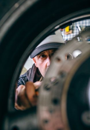 Mechanic fixing custom motorcycle wheel