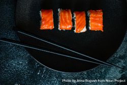 Top view of salmon sushi rolls served on stone slate 5RV2GD