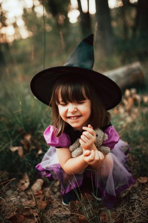 Girl smiling her eyes closed in witch costume