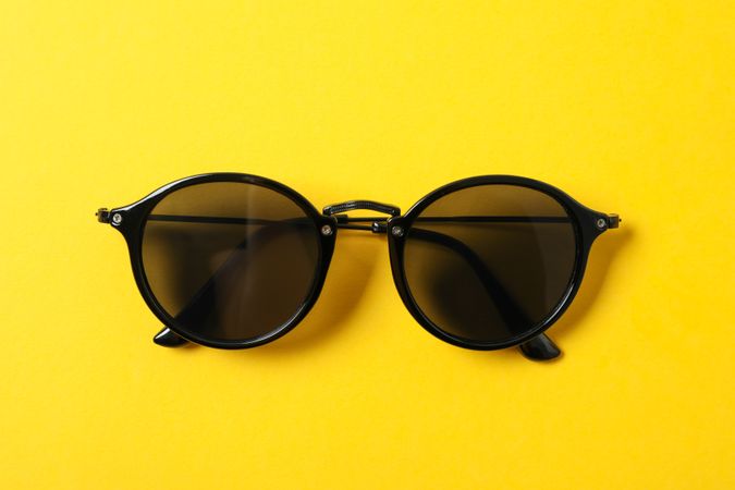 Sunglasses on color background, space for text and closeup. Fashionable accessories