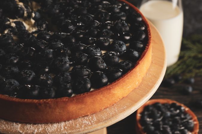 Concept of tasty lunch with blueberry pie on wooden background