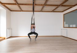 Mother exercising with baby in gym