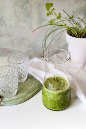 Organic Green smoothie detox drink in a glass bottle