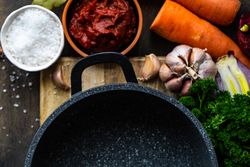 Top view of fresh ingredients for hearty soup surrounding pan