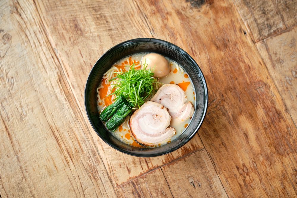 Delicious ramen soup on wooden table