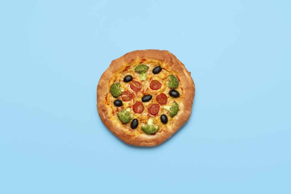 Vegan pizza isolated on blue table