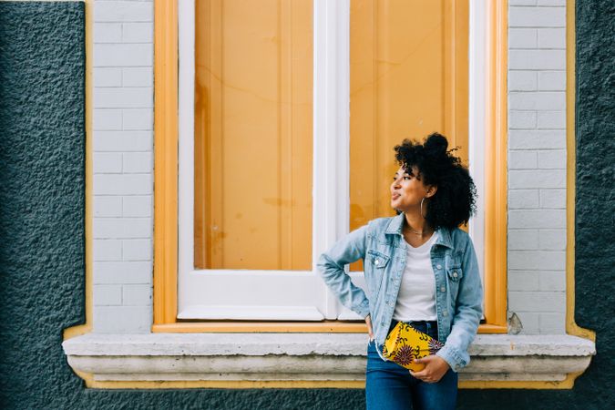Smiling Black female by yellow window