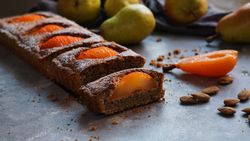 Pear cake and fruits on table