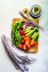 Top view of healthy chopped vegetables on bread board