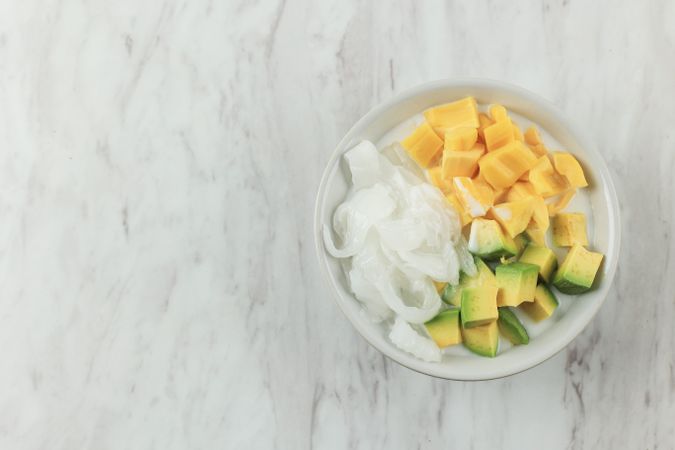 Mango, coconut and avocado Asian dessert with condensed milk