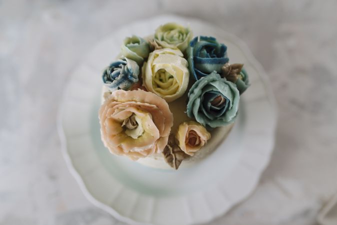 Buttercream flowers cake, blue and pastel peach colors
