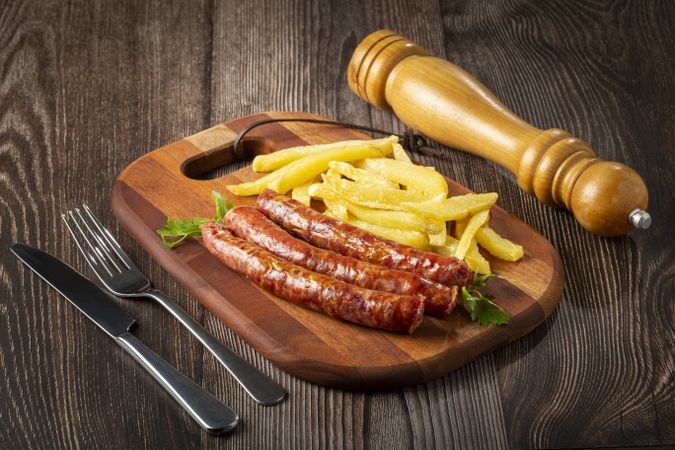 Grilled German sausage with french fries.